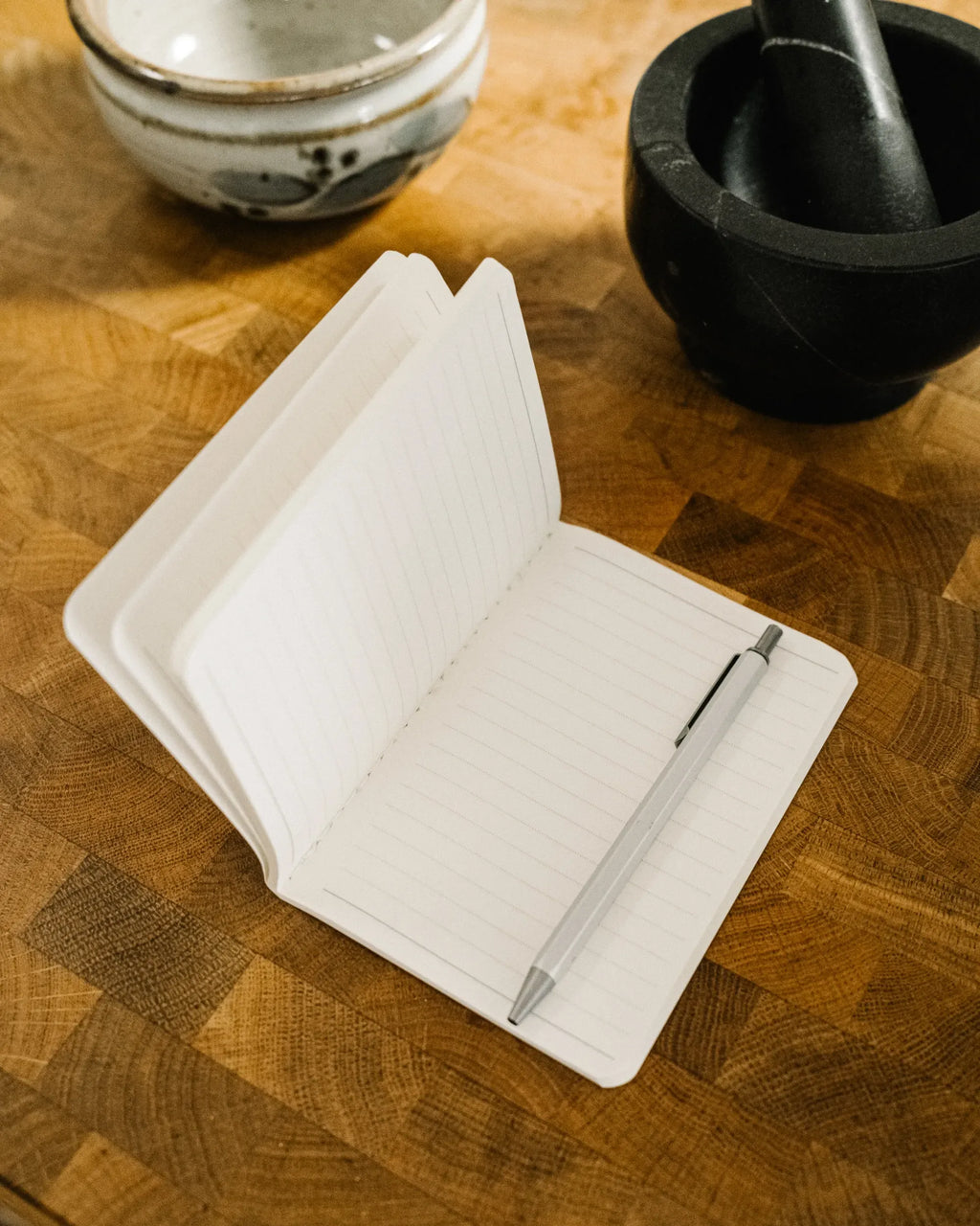Lined pages, open with a pen